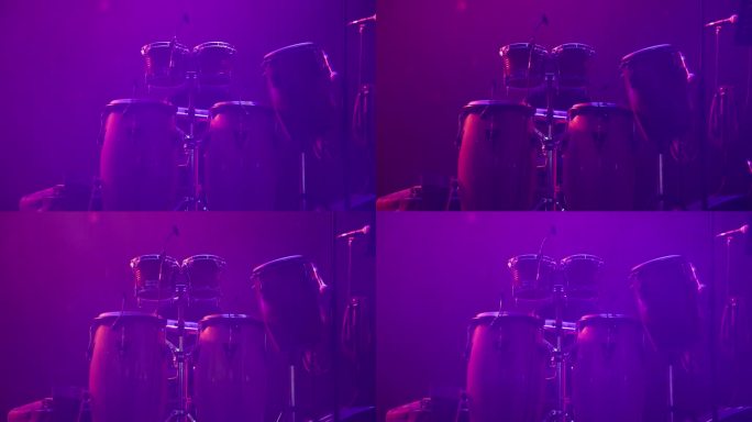 在紫色的舞台灯光下拍摄的充满活力的鼓独奏表演