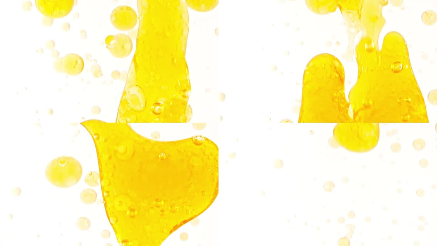 慢动作移动的金黄油，气泡在水中上升在浅白色的背景。带有气泡的透明化妆品凝胶液。微距镜头。