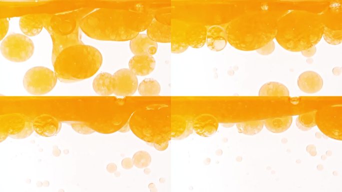 慢动作移动的金黄油，气泡在水中上升在浅白色的背景。带有气泡的透明化妆品凝胶液。宏Shot.v