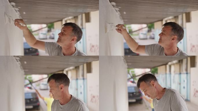 男子粉刷建筑外墙
