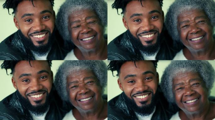 ▽幸福的时代对比= 80多岁的老奶奶和20多岁的儿子对着镜头微笑的特写
