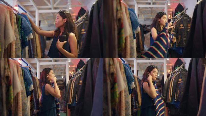 在清迈市中心的一家二手服装店，一位兴高采烈的女游客正在挑选复古服装。