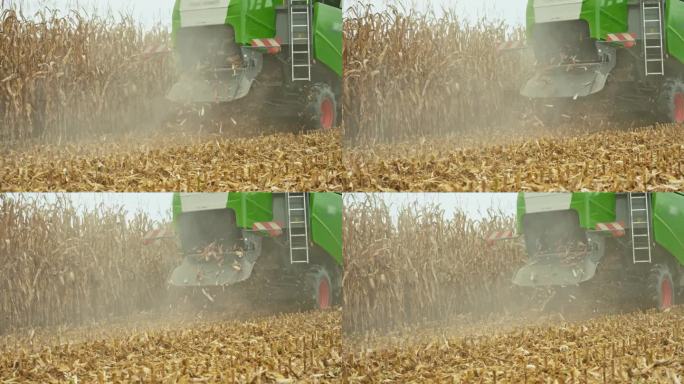 收割时联合收割机在田间抛撒玉米废料的SLO MO跟踪镜头