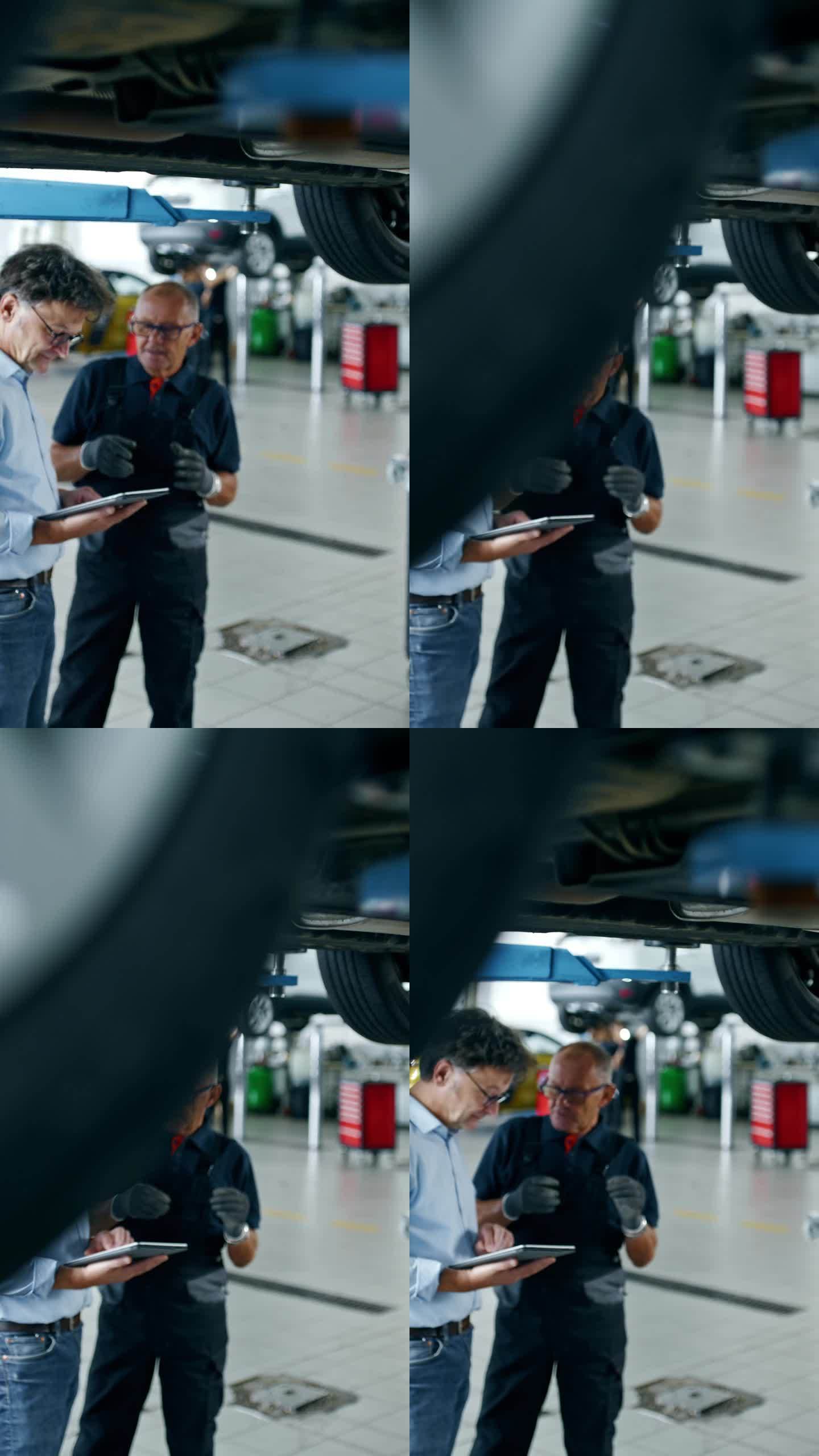 男机械师兼经理，在修理厂车底拿着数码平板电脑