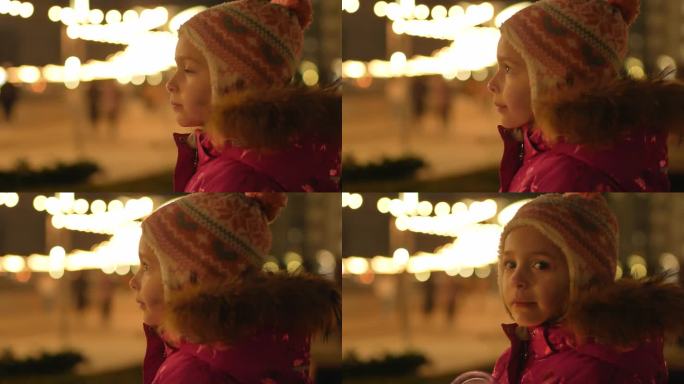 一个穿着冬衣的小女孩在寒风中望着街灯间的远方，期待着圣诞节的到来