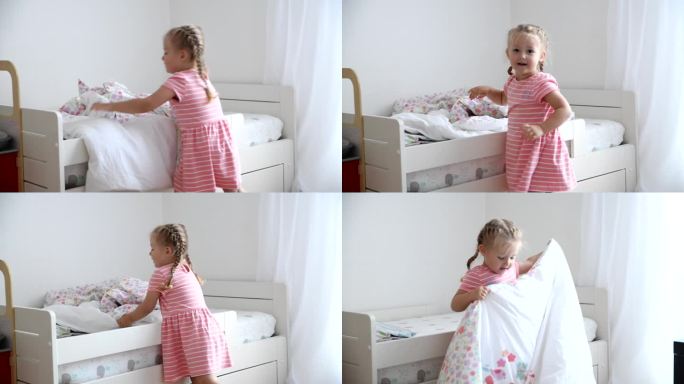 一个3岁的女孩在儿童房铺床
