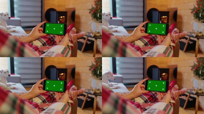 女人躺在沙发上拿着绿屏看色度键屏