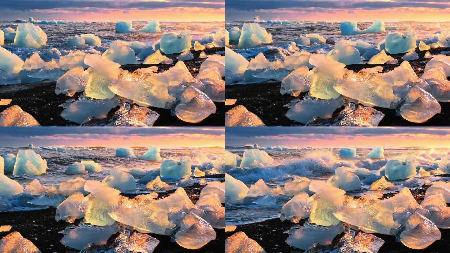 在黄金时段，冰山在黑色的海滩上闪闪发光。冰岛钻石海滩的日出。清澈的冰被海浪击碎。气候变化全球变暖问题