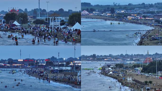 夏日傍晚海边一群人在游玩