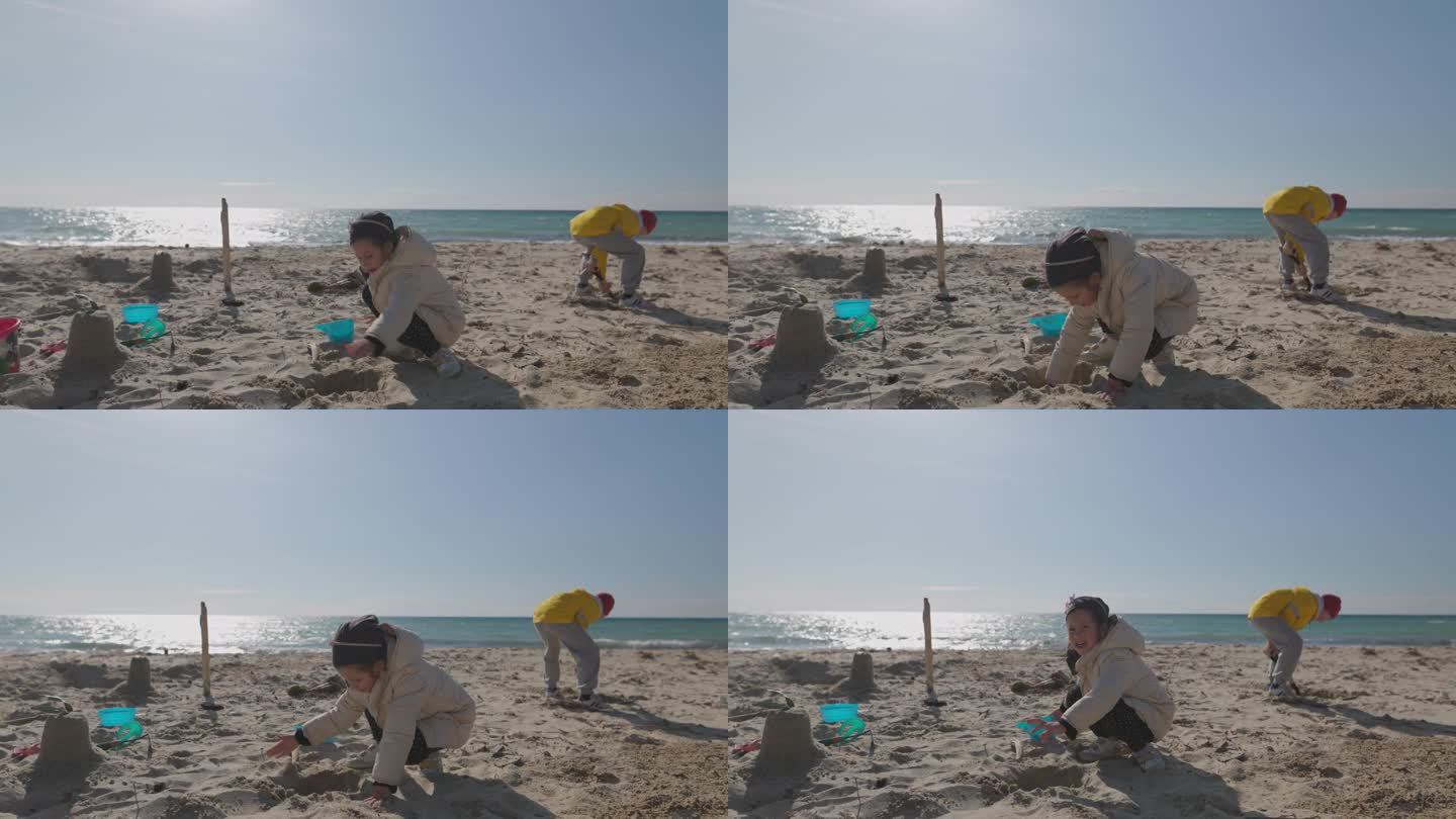 哥哥和姐姐在沙滩上堆沙堡