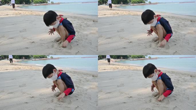 慢动作场景快乐的男孩在沙滩上玩得开心，孩子戴上covid - 19口罩