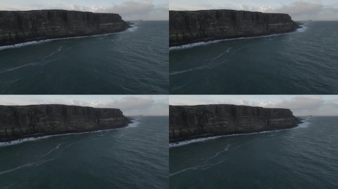鸟瞰图，苏格兰天空中崎岖的苏格兰裙岩悬崖，海浪拍打着海岸