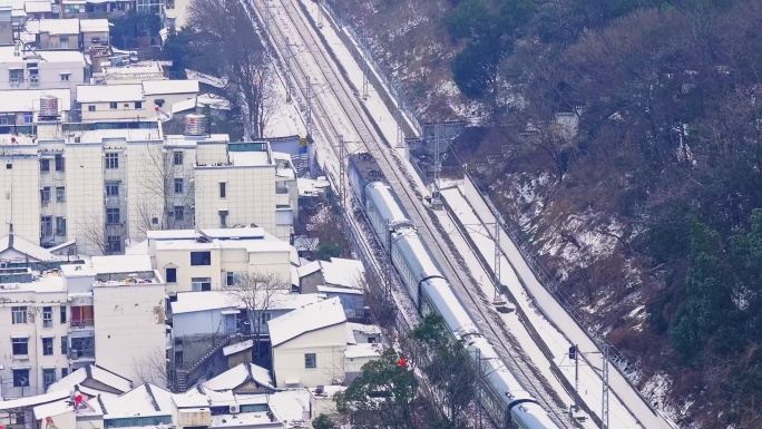 大雪下通过武汉黄鹤楼的客运列车