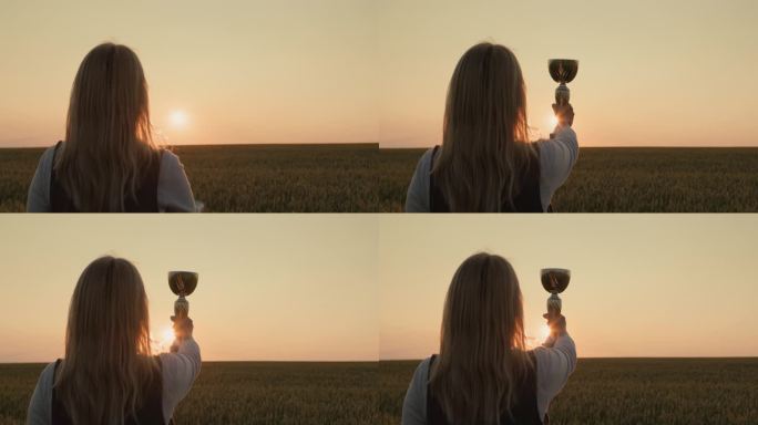 日落时分，农妇在麦田里举起冠军奖杯