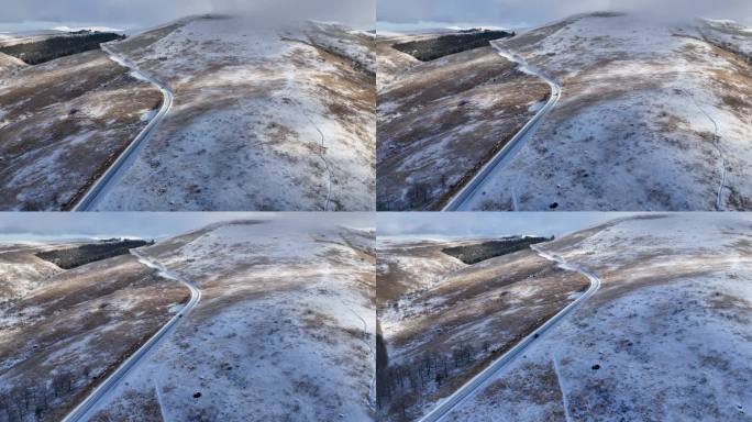 在一个阳光明媚的日子里，鸟瞰白雪覆盖的高原，道路被剩余的雪变白了