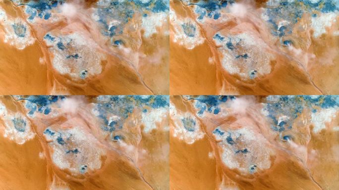 这张精彩的照片显示了活跃的地热喷口，在稳定的模式下，拍摄了蓝色的水和泥点，棕色的橙色地形和白色的硫磺