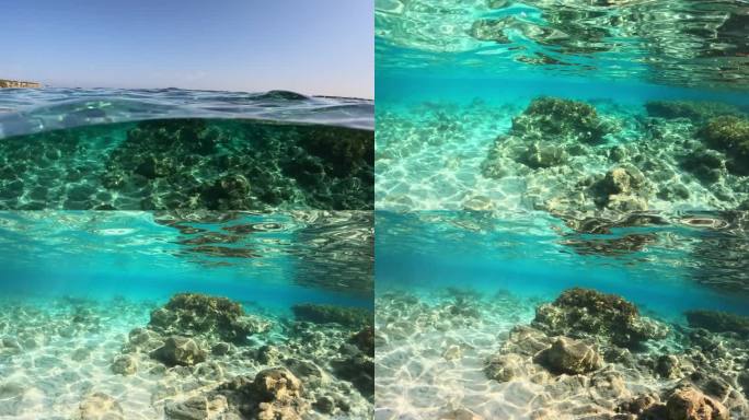 镜头慢慢移动到塞浦路斯海岸清澈的绿松石海水中。在塞浦路斯的蓝色泻湖海滩上，水晶般清澈的海水的分割慢动