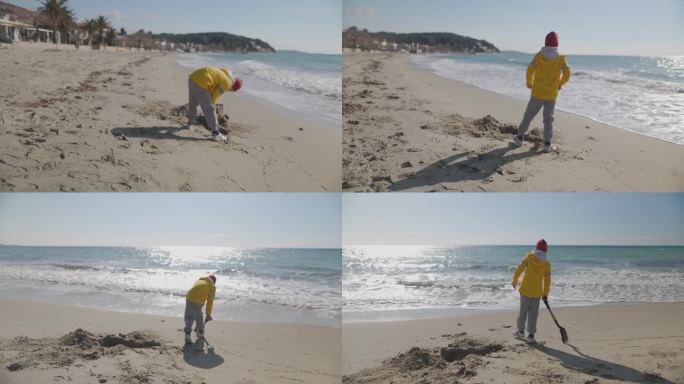 寒假期间在沙滩上玩铲子的快乐男孩