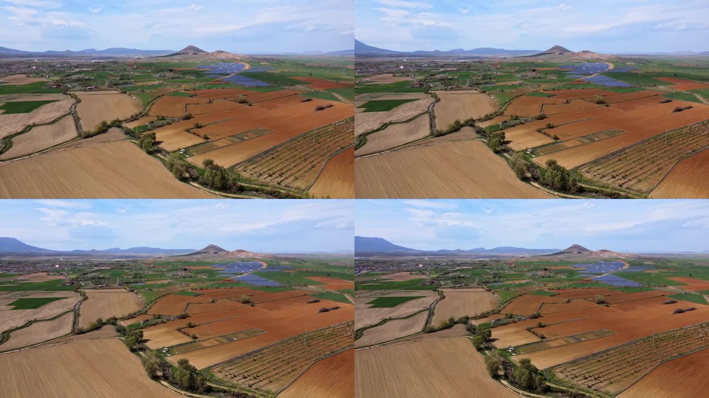 无人机拍摄的农田和太阳能发电厂背景。可持续的资源和生活方式