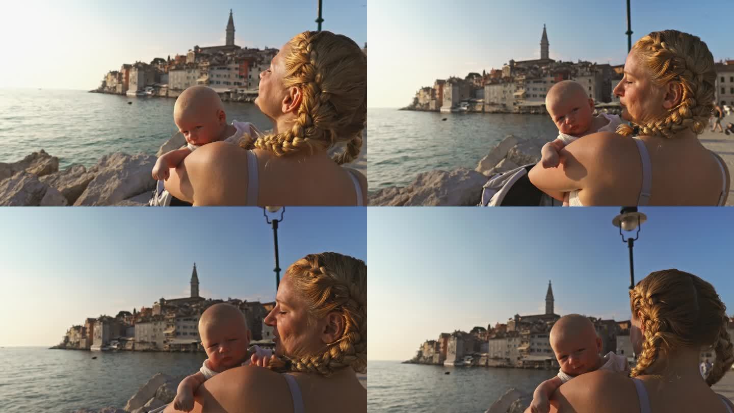 阳光明媚的一天，母亲带着蹒跚学步的孩子在海边度假。罗维尼，伊斯特拉，克罗地亚。