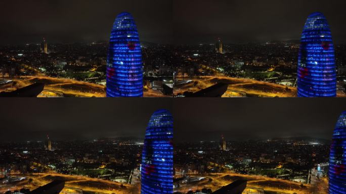 夜间照明巴塞罗那市著名的办公大楼外部交通街道航拍全景4k西班牙