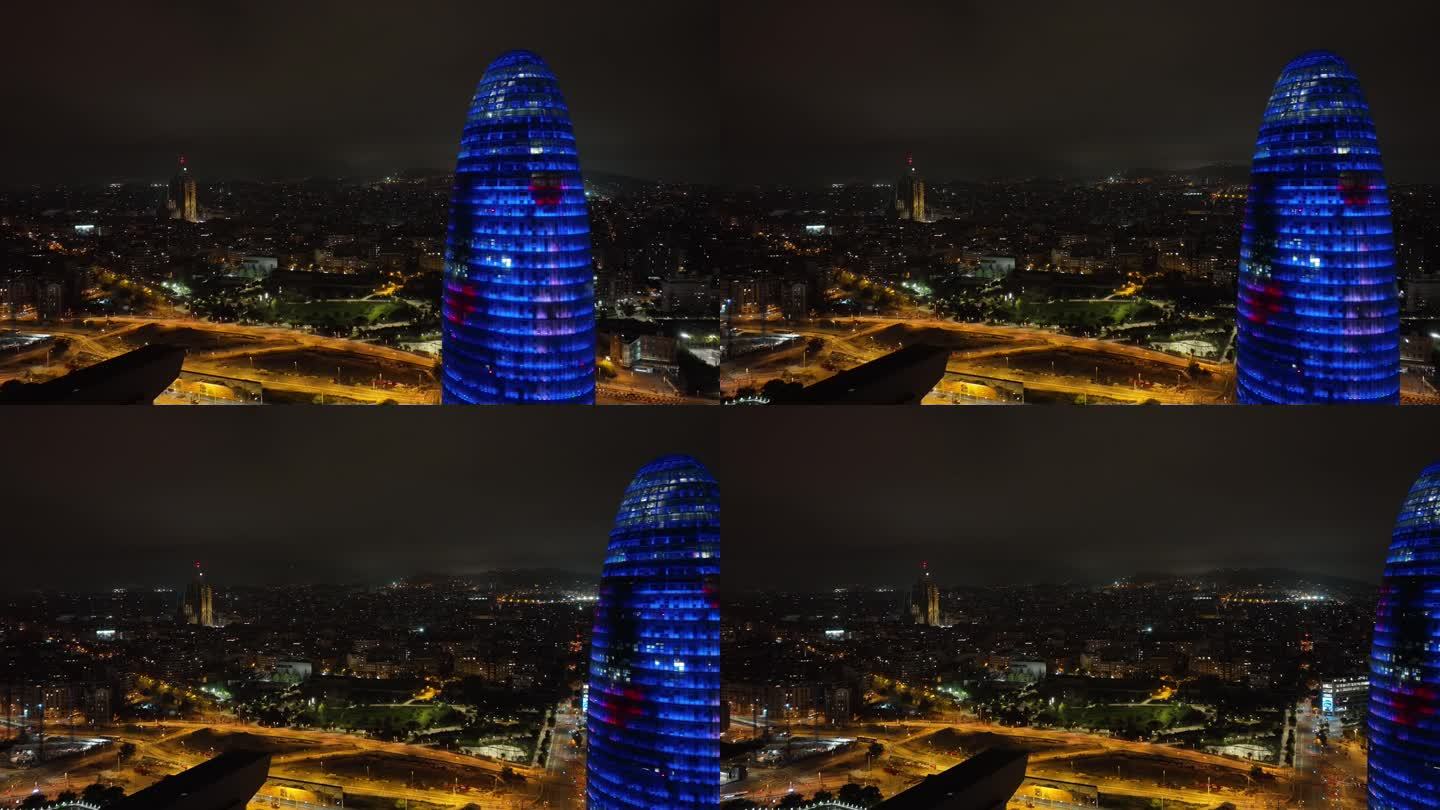 夜间照明巴塞罗那市著名的办公大楼外部交通街道航拍全景4k西班牙