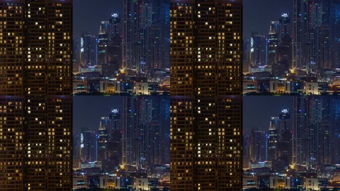 夜间迪拜市中心摩天大楼住宅前屋顶全景4k延时阿联酋