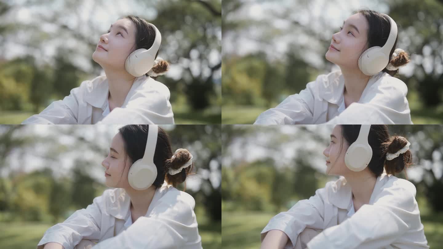 一个女人坐在舒适的公园草地上，听着她最喜欢的歌，感觉很快乐。