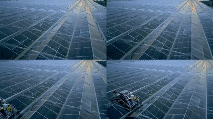 日落时温室玻璃屋顶的高角度全画幅无人机拍摄