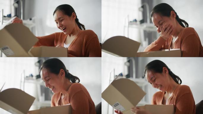 快乐的亚洲女人在家里打开盒子