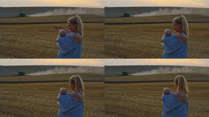 女农学家扛着儿子，看着拖拉机在夕阳下犁地