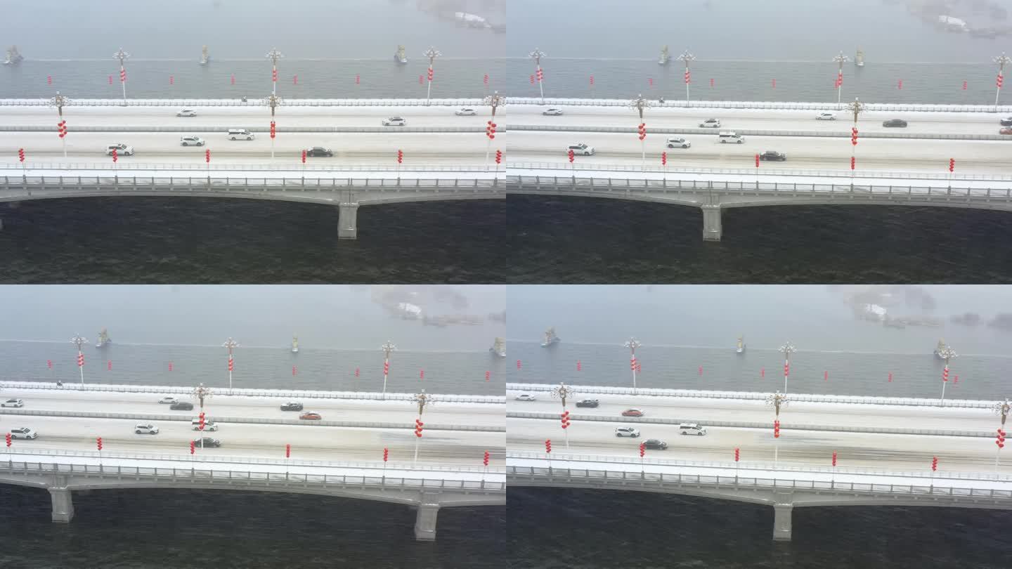 4K航拍下大雪天气汽车行驶在大桥上