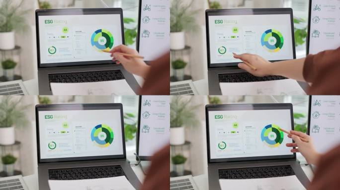 企业家在可持续发展办公室的笔记本电脑屏幕上分析环境、社会和治理(ESG)投资数据评级;