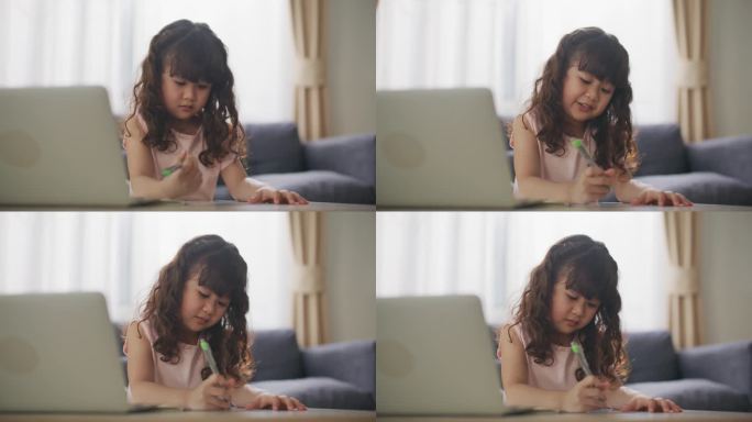 女儿在家做作业小女孩在写字