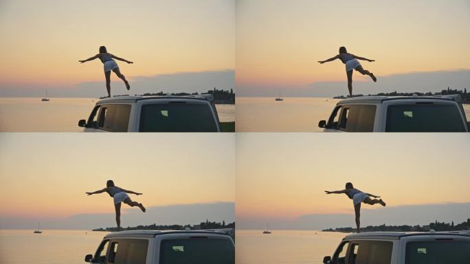 日落时分，女子在海边露营车上练习放松运动的慢镜头镜头