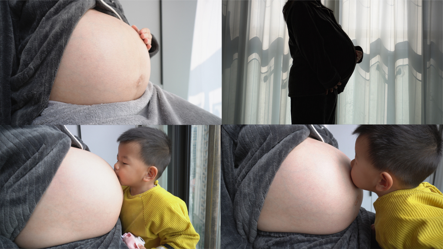 孕妇在窗台晒太阳抚摸肚子小孩过来轻吻肚子