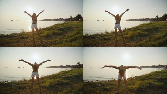 悠闲的女人举起手臂在湖岸享受假期的慢镜头