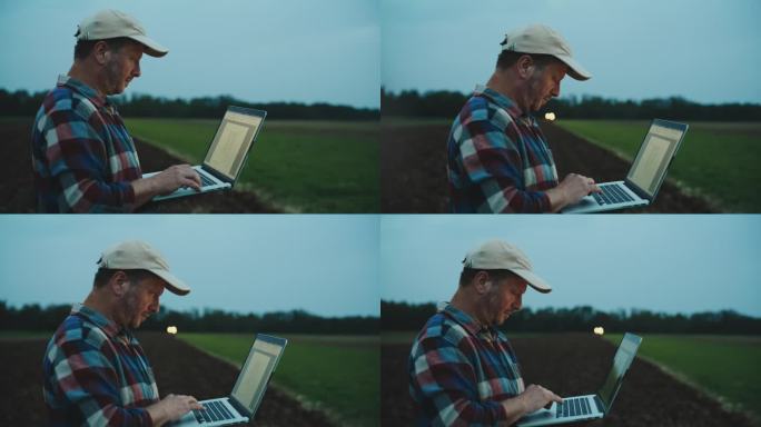 SLO MO专门的男性环保人士在黄昏时分在野外行走时使用笔记本电脑