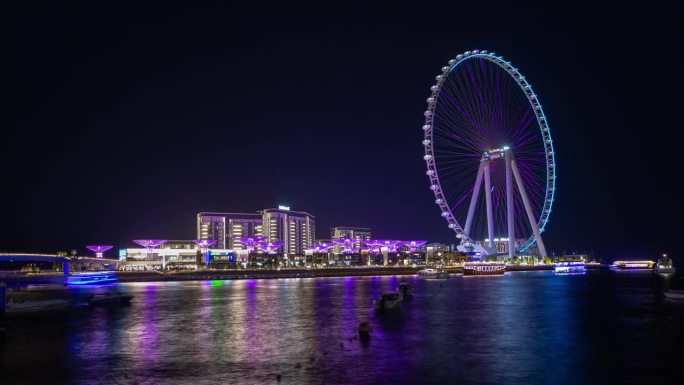 夜间照明迪拜市著名的摩天轮岛海湾全景4k延时阿联酋