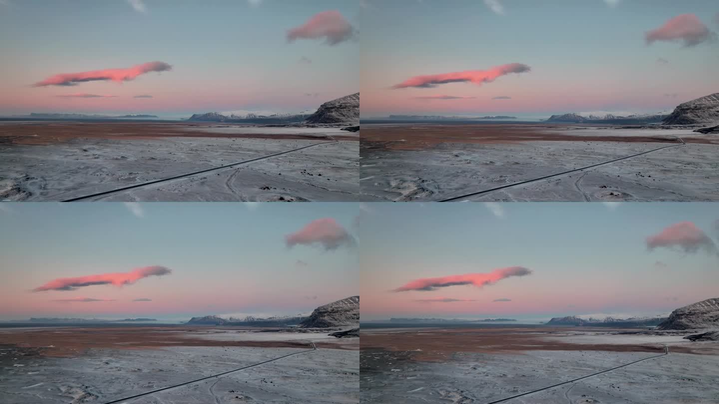 冰岛南部Oraefi，冬季雪景上的粉色日出。无人机回射