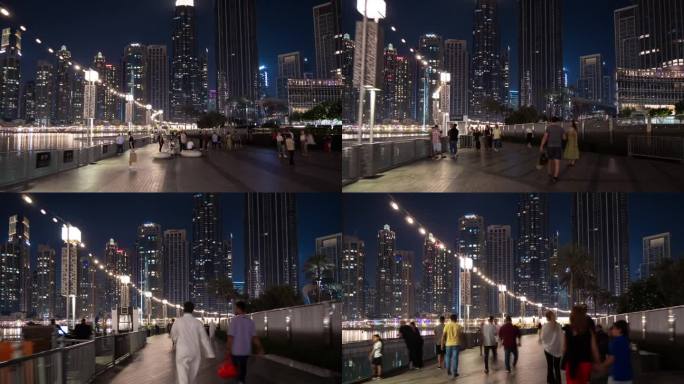 夜晚照亮迪拜城著名的市中心购物中心喷泉拥挤的广场步行全景4k延时阿联酋