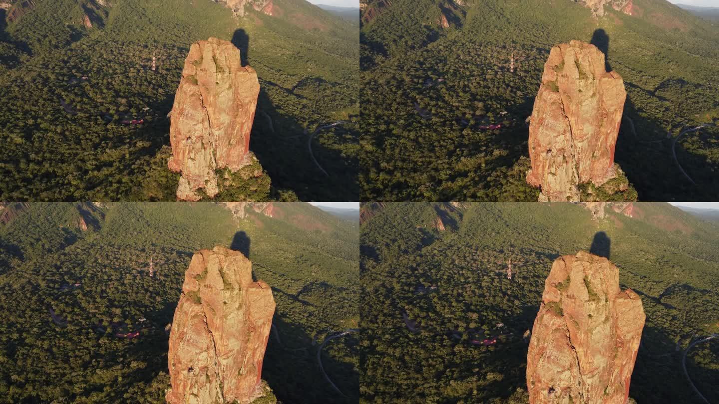 黄金时间航拍:岩石塔在玻利维亚森林上投下黄昏的影子