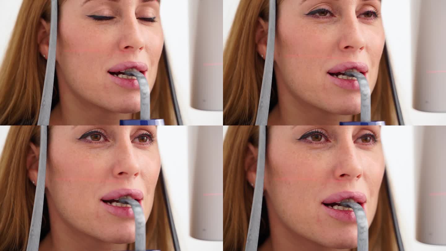 头部全景x光机拍摄的女性脸部特写。女病人站在牙科x光机前进行牙科x光摄影。拍下巴全景的女人。