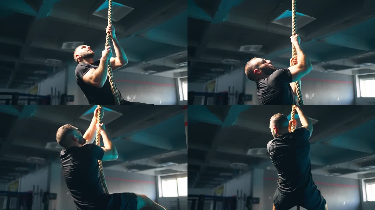 强壮的男运动员在健身房攀绳