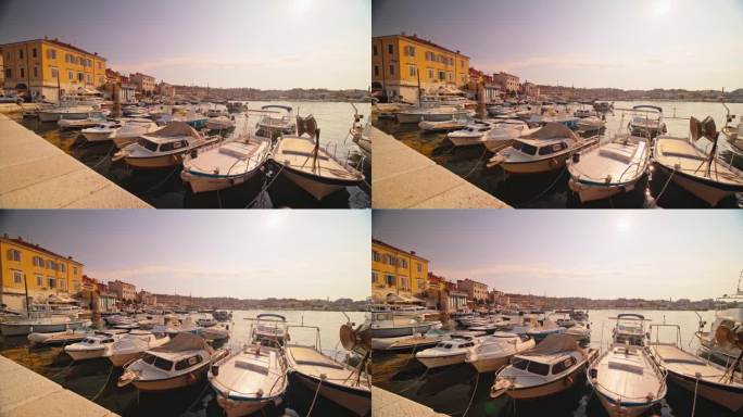 在阳光明媚的日子里，停泊在著名历史小镇港口的船只的SLO镜头。克罗地亚，罗维尼，伊斯特拉。