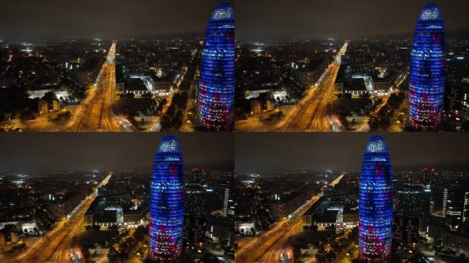 夜晚照亮巴塞罗那市著名的交通街道办公大楼航拍全景4k西班牙