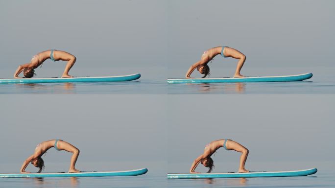 在阳光明媚的日子里，穿着比基尼的女子在冲浪板上练习瑜伽