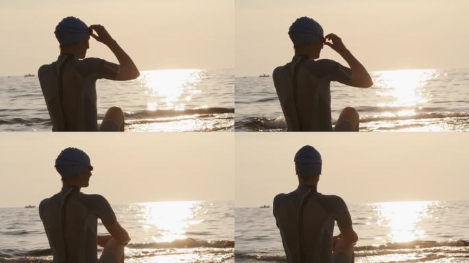 女子戴泳镜在沙滩上看日落的慢镜头镜头