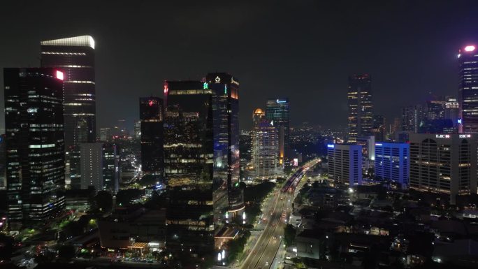 夜间照明雅加达市区现代办公大楼交通街道道路航拍全景4k印尼