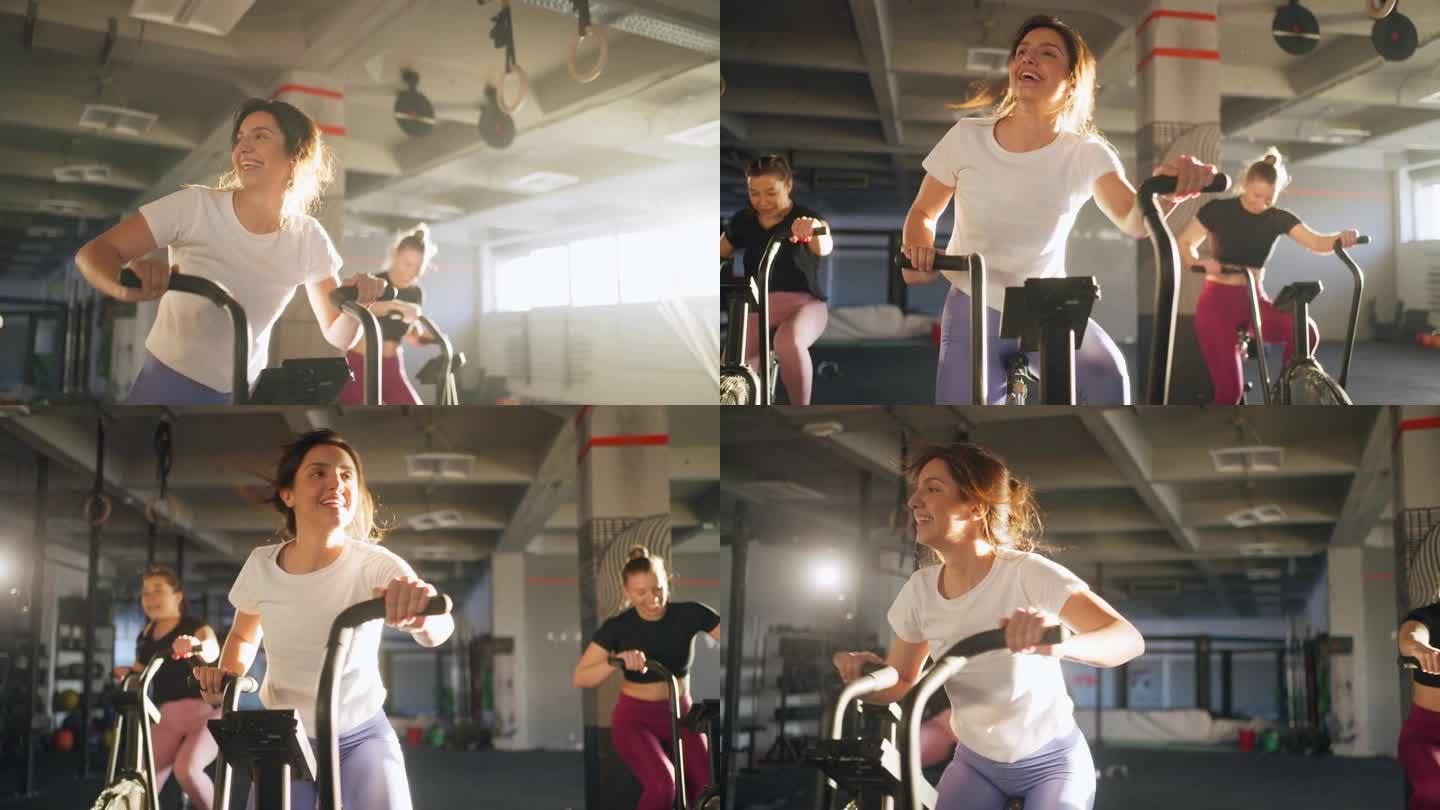 白人女运动员，在健身房的固定自行车机上一起锻炼